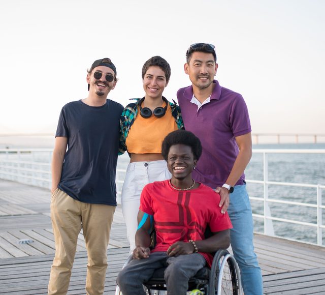 square-kampus-pier Group of four friends smiling on a boardwalk by the water